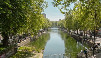 Paris, France April 20, 2022: Panoramic view of the famous Canal Saint Martin, with people on the banks of Paris, France.