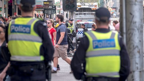 Victorian police officers stand guard in the aftermath of Thursday's Flinders Street rampage.