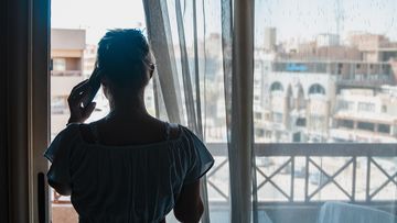 Woman at window during self isolation