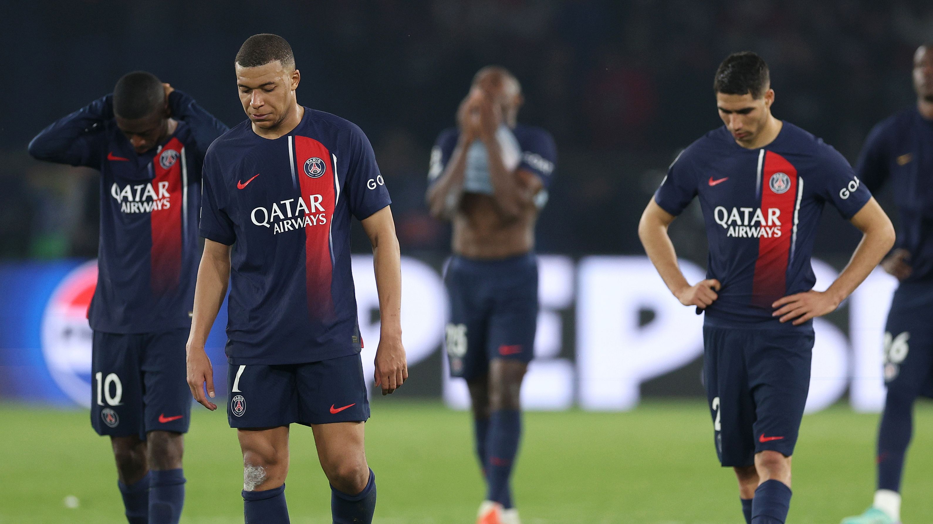 Kylian Mbappe of Paris Saint-Germain looks dejected with teammates after defeat to Borussia Dortmund during the UEFA Champions League semi-final second leg match between Paris Saint-Germain and Borussia Dortmund at Parc des Princes.