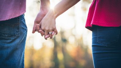 Couple holding hands outdoors