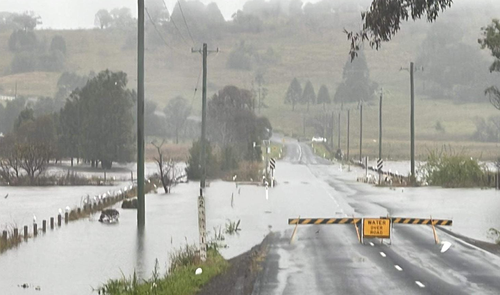 A weather system moving down the coast from Queensland has brought unseasonably heavy rain to flood-prone parts of northern NSW