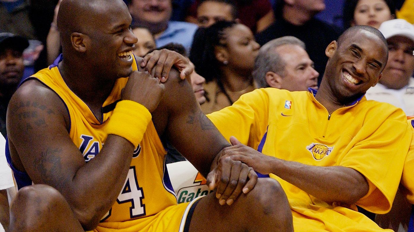 In this April 15, 2003, file photo, Los Angeles Lakers Shaquille O&#x27;Neal, left, and Kobe Bryant share a laugh on the bench