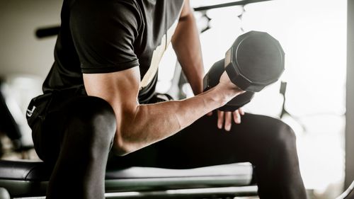 Man lifting weights in gym