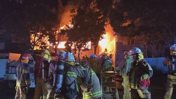 Three people were taken to hospital after a house fire in Brisbane which spread to two other buildings.