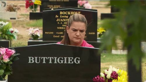 Ms Saunders at her daughter's grave. (9NEWS)