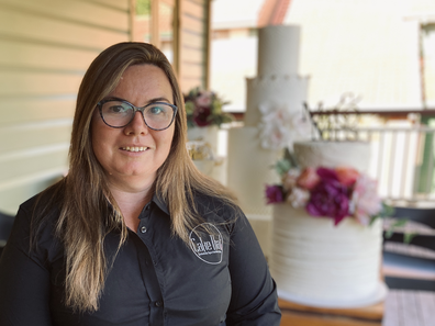 Founder of Cake That!, Sarah-Jane Wicks, pictured next to inedible Styrofoam wedding cakes she created specially for wedding displays.