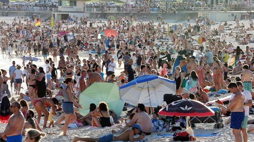 Beachgoers are seen at Bondi Beach despite the threat of Coronavirus (COVID-19) in Sydney, Friday, March 20, 2020. 