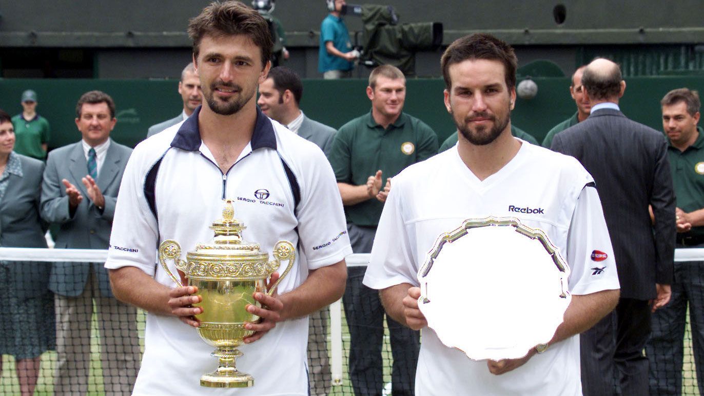 Goran Ivanisevic of Croatia celebrates with the trophy after beating Australia&#x27;s Pat Rafter to win the 2001 Wimbledon final.