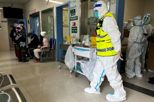 Security keeps watch as medics attend to patients at Tongji Hospital in Wuhan, a major facility for patients of the coronavirus disease.