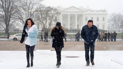 Snow begins to fall at President's Park across the street from the White House, in Washington, DC. (AAP)