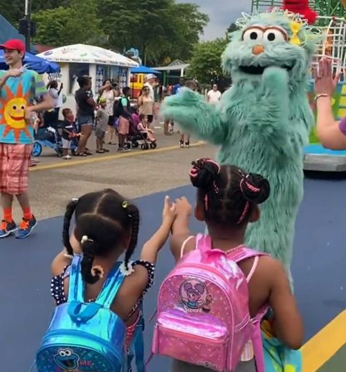 The girls reached out for a hug from the Sesame Street character.