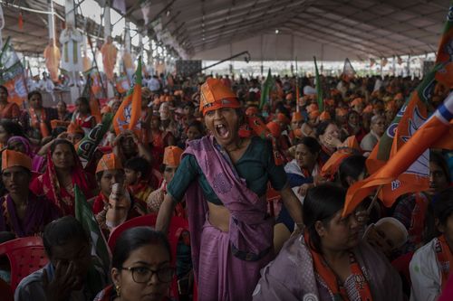 India election: A supporter of India's ruling Bharatiya Janata Party (BJP) yawns as she attends an election rally addressed by Indian Prime Minister Narendra Modi.