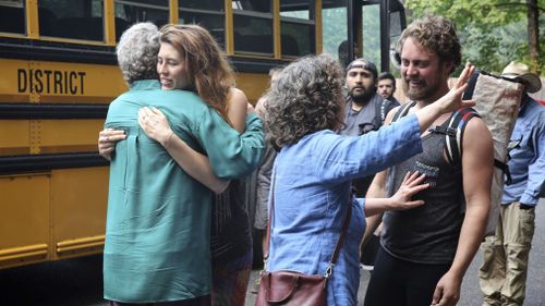Families reunite after campers were evacuated from a forest fire in the Eagle Creek area of the Columbia River Gorge. (Associated Press)