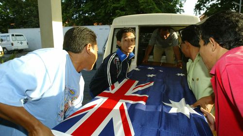 Three coffins containing Australian victims of the 2005 Bali bombings, draped in an Australian flag.