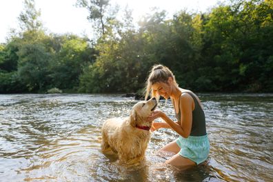 Person swimming with dog