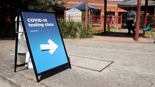 A sign guiding people is seen outside a NSW Health Pop-up COVID-19 clinic at Lakemba Uniting Church on October 15, 2020 in Sydney, Australia. 