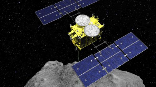 This computer graphics image released by the Japan Aerospace Exploration Agency (JAXA), shows how the Hayabusa2 spacecraft released an explosive onto an asteroid to make a crater on its surface and collect underground samples.