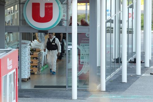 Forencis officers are combing the supermarket in Trebes where the gunman took hostages during the rampage. (AAP)