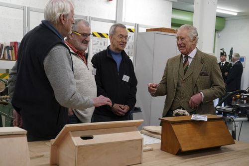 King Charles III reacts during a visit to the Aboyne and Mid Deeside Community Shed to meet with local hardship support groups and tour the new facilities, in Aboyne, Aberdeenshire, Scotland, Thursday, Jan. 12, 2023 