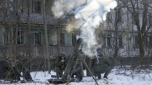 The National Guard soldiers take part in tactical exercises, which are conducted by the Ukrainian National Guard, Armed Forces, special operations units and simulate a crisis situation in an urban settlement, in the abandoned city of Pripyat near the Chernobyl Nuclear Power Plant, Ukraine, Friday, Feb. 4, 2022. (AP Photo/Mykola Tymchenko)