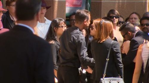 A crowd of weeping mourners gather for Mr Johnson's funeral. (9NEWS)