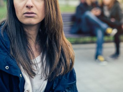 Woman third wheeling with couple.