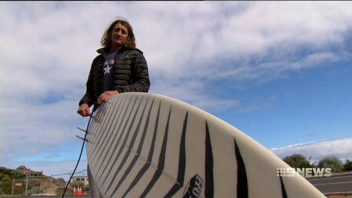 Robby Bruce, 60, has described the moment a shark swiped him clean off his surf board. (9NEWS)