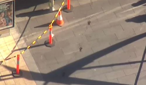 Bloody footprints could be seen near where the stabbing occurred. (9NEWS)