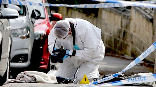 Forensic police collect evidence from the crime scene. (AAP)