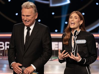 Wheel of Fortune US host Pat Sajak with celebrity guest Sarah Levy 