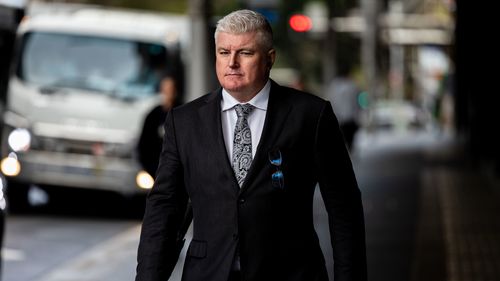 Former Australian cricketer Stuart MacGill arrives at Downing Centre Local court, Friday, 9 May 2025.    Macgill, an Australian cricketing great  will this morning learn whether he will be jailed after being found guilty by a District Court jury of helping to set up, and being present at, a meeting between the man and a street-level drug dealer, who can only be known as Person A, underneath his Neutral Bay restaurant in April 2021.   Photo: Sam Mooy / The Sydney Morning Herald