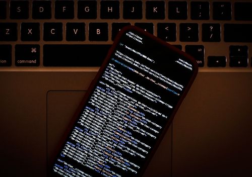 HTML code is seen on a smartphone.