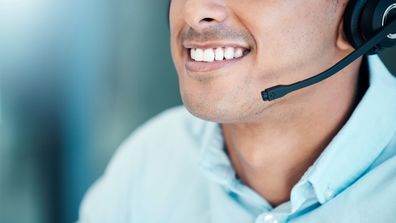 call centre operator on phone face close smiling teeth