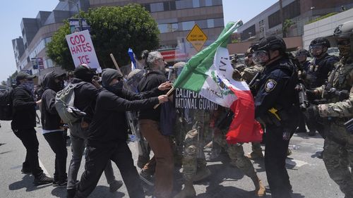 Protesters clash with authorities in downtown Los Angeles, Sunday, June 8, 2025, following last night's immigration raid protest. (AP Photo/Jae Hong)
