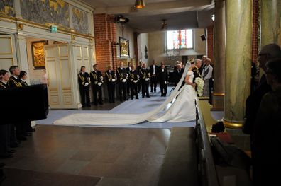 Crown Princess Victoria of Sweden is led into the church by her father the king Carl Gustaf of Sweden.