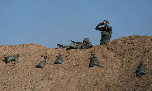 Israeli soldiers are seen near the border with the Gaza Strip, southern Israel, Thursday, Nov. 30, 2023. during a temporary cease-fire between Israel and Hamas.