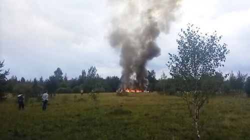 Smoke and flames rise from a crashed private jet near the village of Kuzhenkino, Tver region, Russia, Wednesday, Aug. 23, 2023