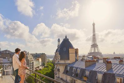 Romantic in love man woman couple in Paris Eiffel Tower embrace honeymoon destination