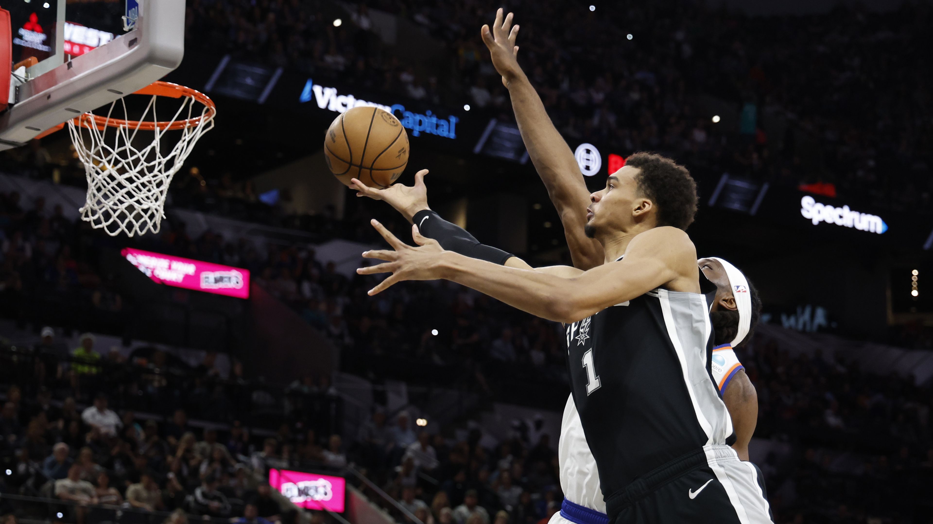 Victor Wembanyama of the San Antonio Spurs drives past Precious Achiuwa of the New York Knicks.