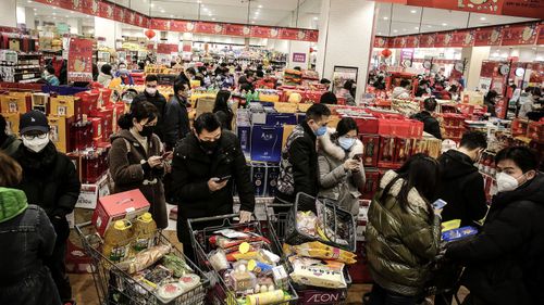 Wuhan residents shopping in a market in January this year.