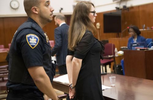 Court officers escort Anna Sorokin from the courtroom, 