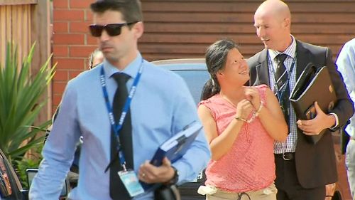 Amy Tran (in pink) smiled after being arrested over the bashing of a 77-year-old woman.