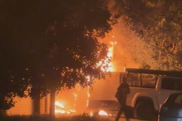 Vision has captured the moment hero neighbours rushed to save the life of a man who fled his burning home south of Brisbane overnight.