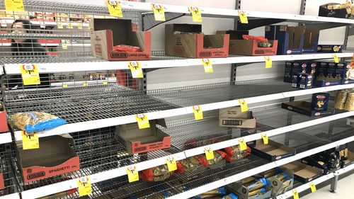 Supermarket shelves emptied of pasta and spaghetti.