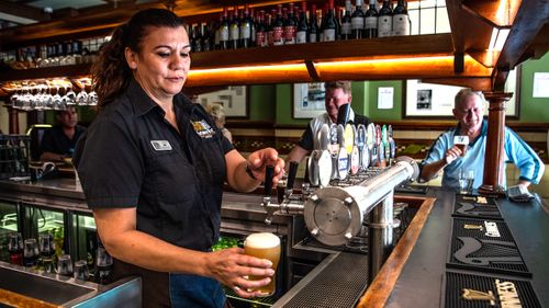 Jennifer Rounds pouring last drinks at Fortune of War, Sydney's oldest pub, prior to closing its doors at 12 noon, due to the COVID-19 pandemic lockdown, on March 23, 2020.