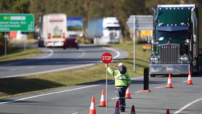 Queensland Police stop vehicles on the border with NSW.