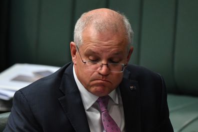 Prime Minister Scott Morrison reacts during Question Time in the House of Representatives, while outside, thousands of angry protesters march on the lawns of Parliament House. 