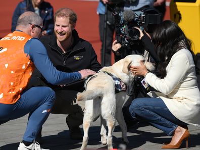 Prince Harry, Duke of Sussex and Meghan, Duchess of Sussex interact with members of Team Netherlands during the Athletics on day two of the Invictus Games The Hague 2020 at Zuiderpark on April 17, 2022 in The Hague, Netherlands. (Photo by Lukas Schulze/Getty Images for Invictus Games The Hague 2020)
