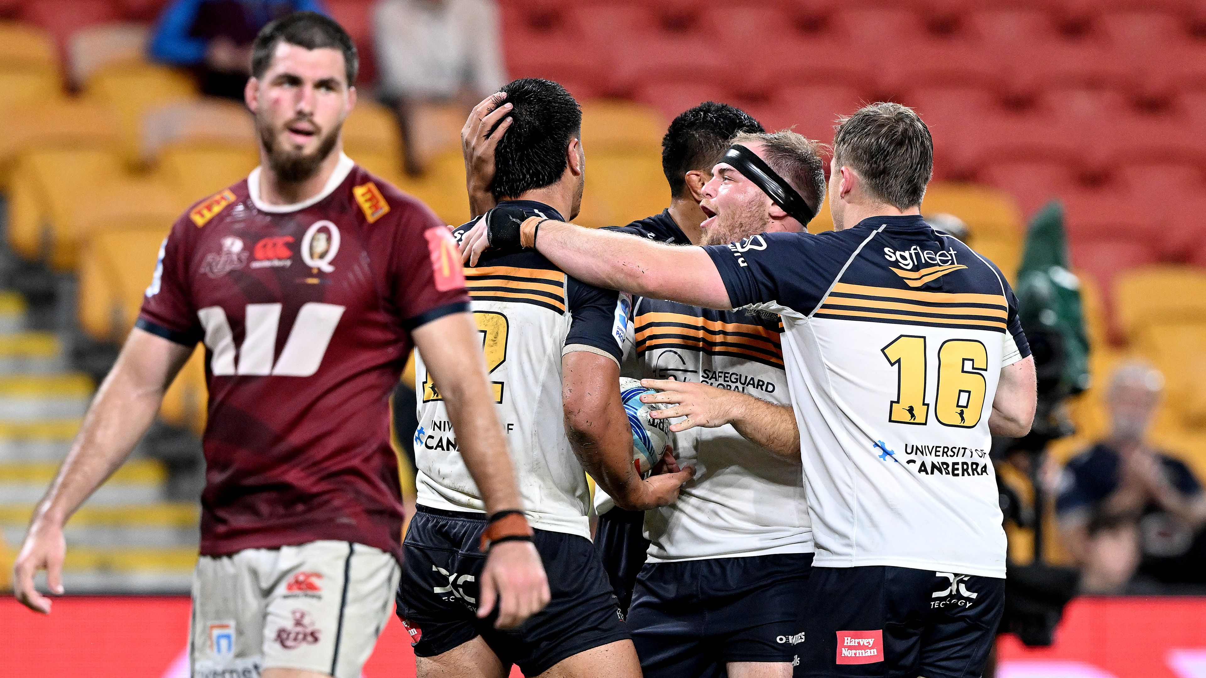 Tamati Tua of the Brumbies celebrates with team mates after scoring a try.